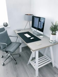 Architectural desk organizers, glass paperweight, and minimalist clock on desk