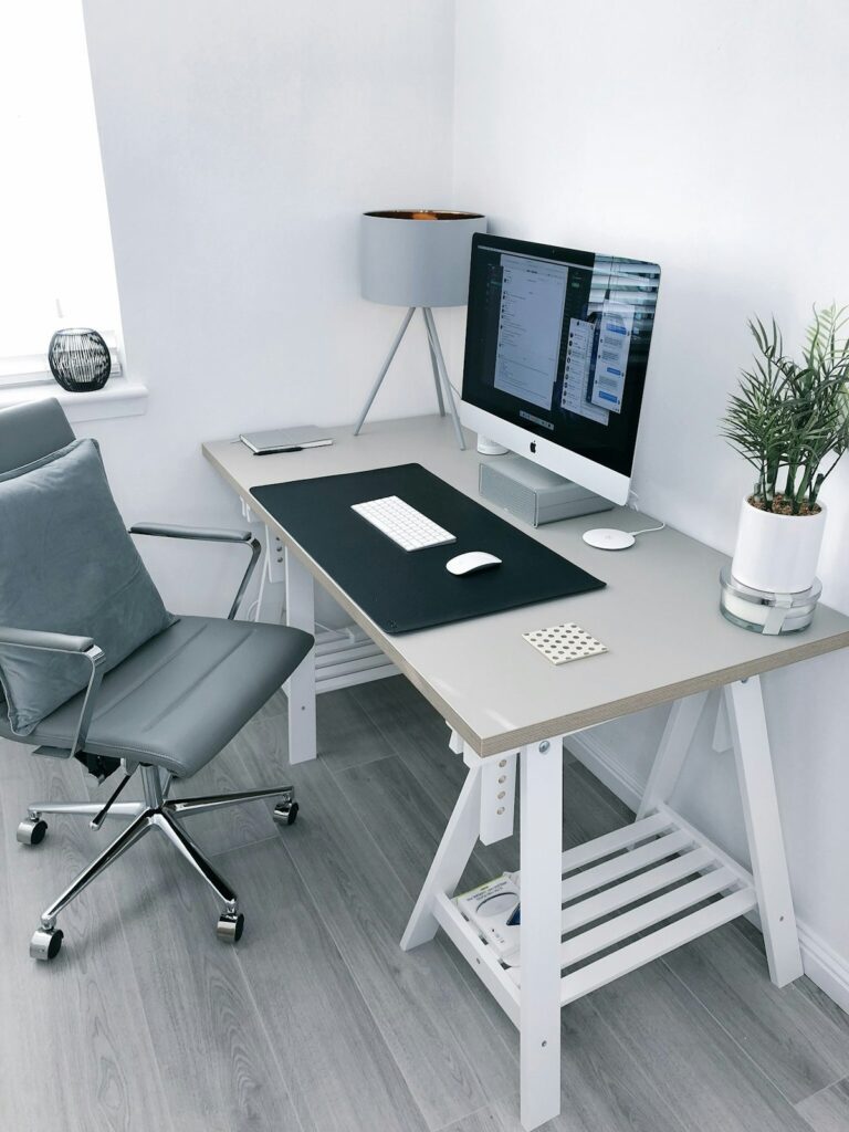 Architectural desk organizers, glass paperweight, and minimalist clock on desk